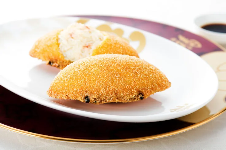 Baked stuffed crab shell with golden breadcrumb crust at Fook Lam Moon.