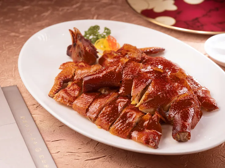 Whole crispy chicken with shattered golden skin — Fook Lam Moon's signature dish.